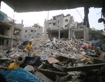 Palestinians inspect the rubble in Rafah refugee camp, Gaza Strip