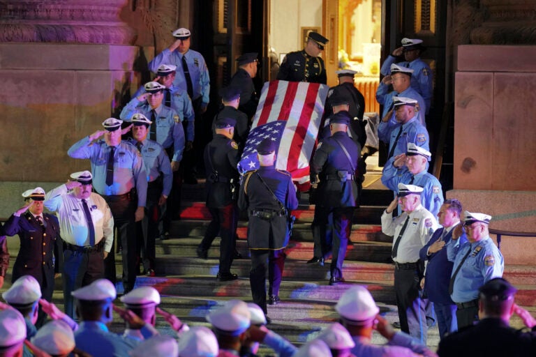Officers salute as the casket arrives at the Cathedral Basilica of Saints Peter & Paul in Philadelphia for the funeral service for slain Police Officer Richard Mendez, Tuesday Oct. 24, 2023.