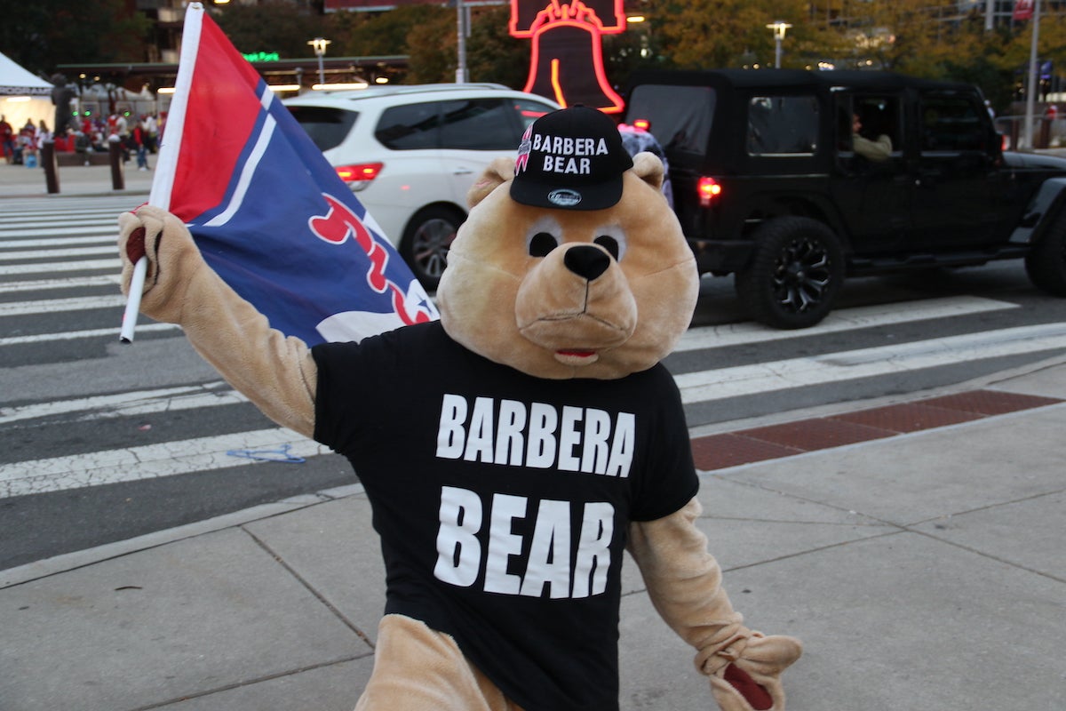 A person wearing a bear costume and a shirt that reads 