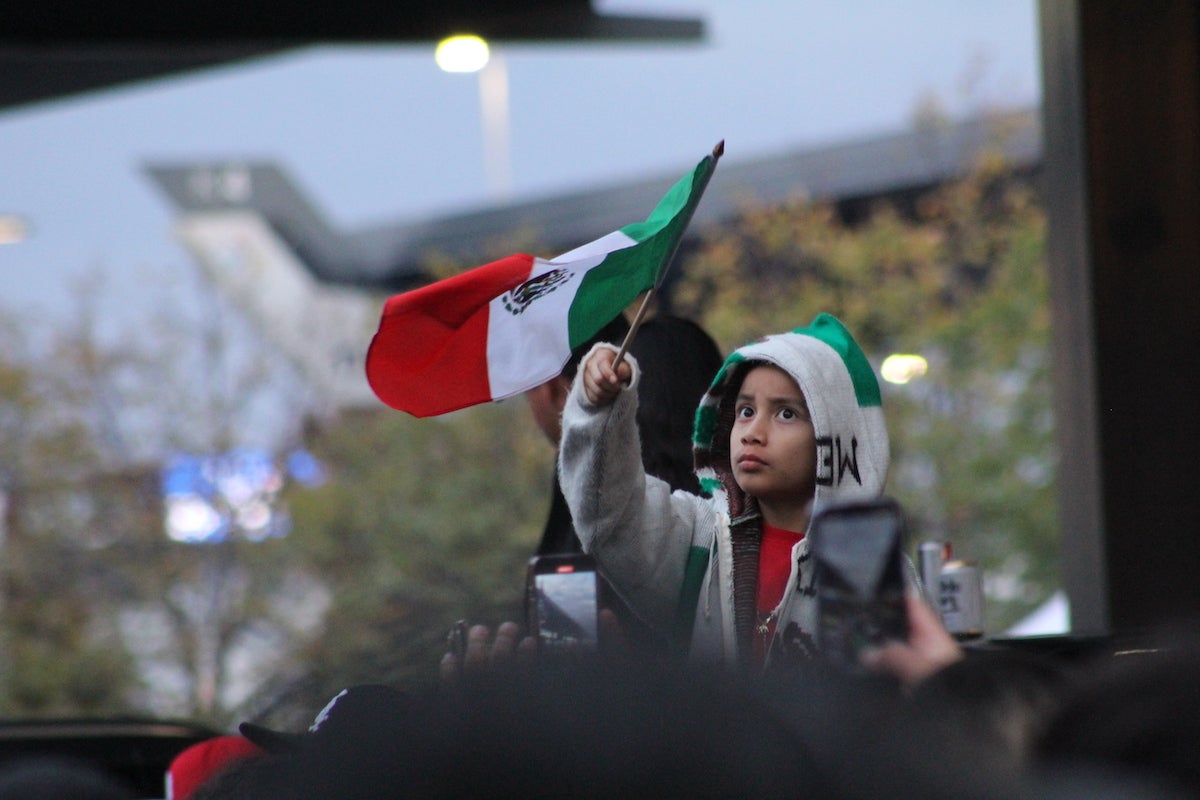 A fan flies a Mexican flag