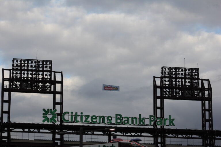 A plane flying a banner that reads 