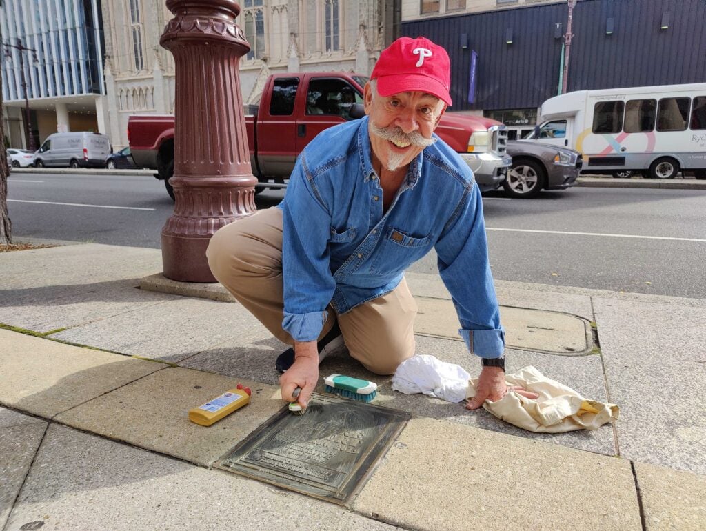 DJ John DeBella cleaning a plaque