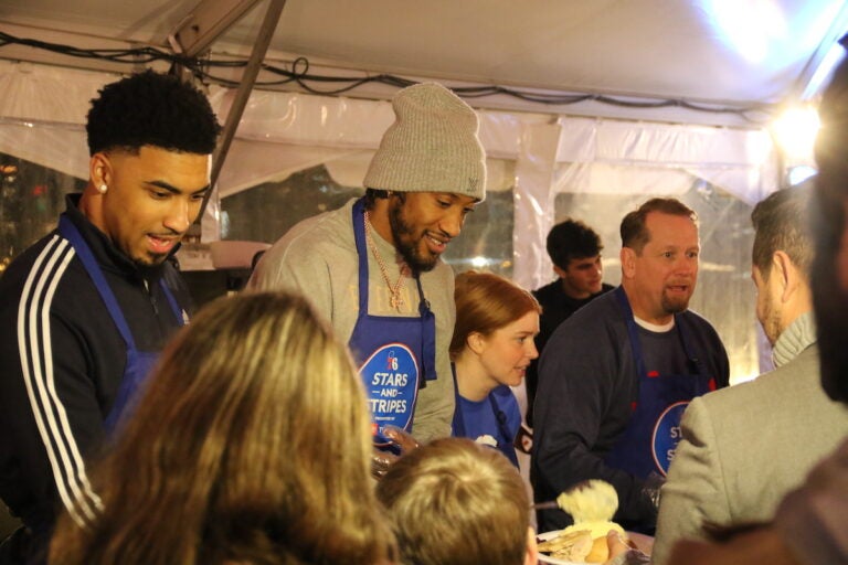 Members of the Philadelphia 76ers served meals to military service members and veterans onboard the Battleship New Jersey on Monday. (Cory Sharber/WHYY)