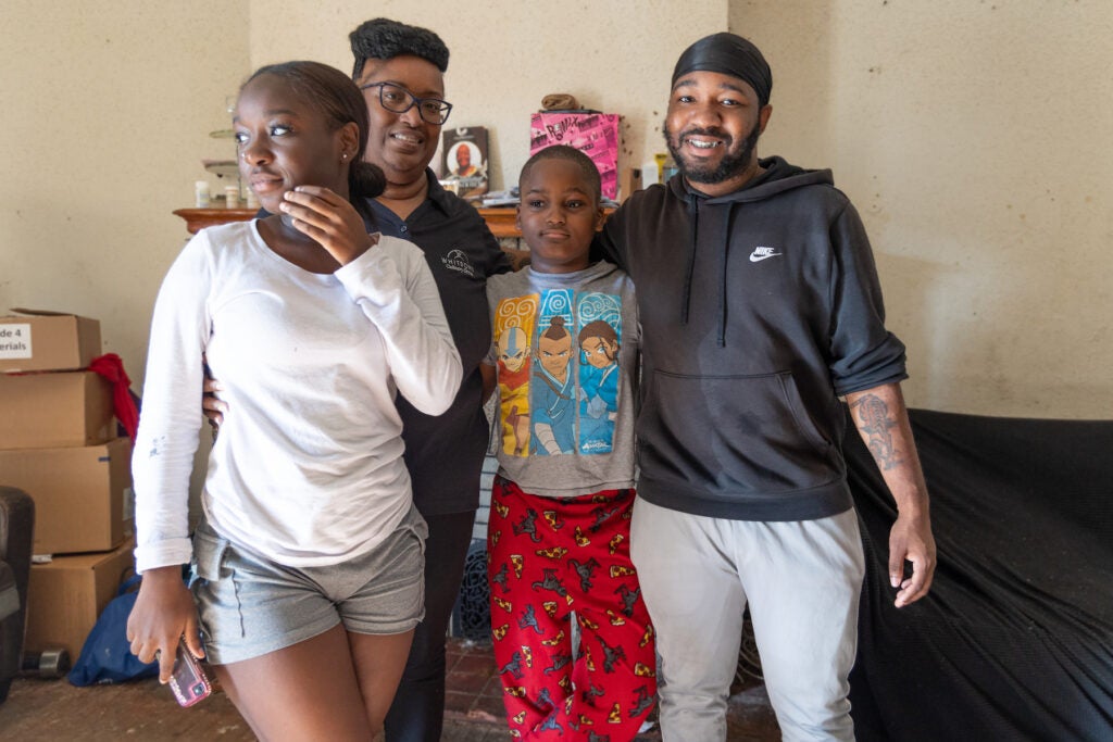 Kia McCray posing for a photo with 3 of her children