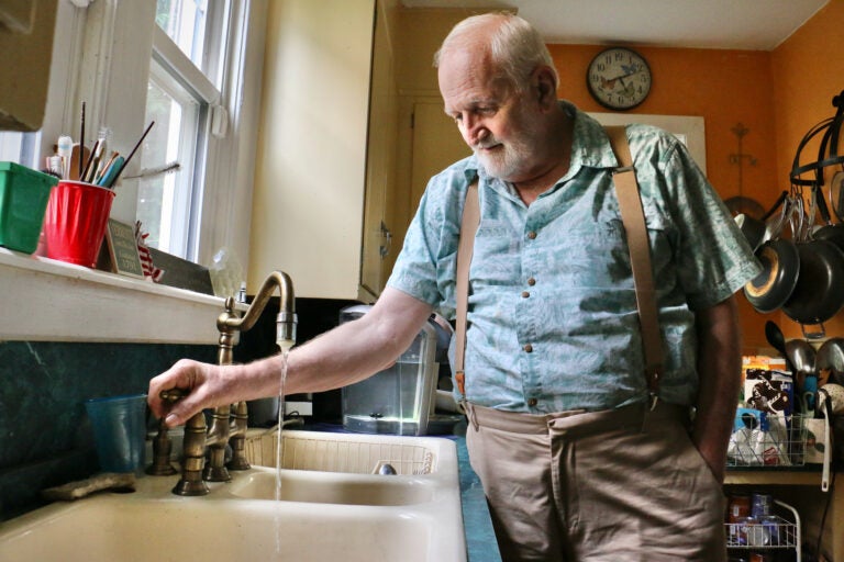 Douglas Frost turns on the tap in his Salem, N.J., home.