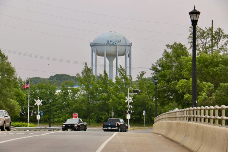 A water tower in the distance with the word Salem written on it.