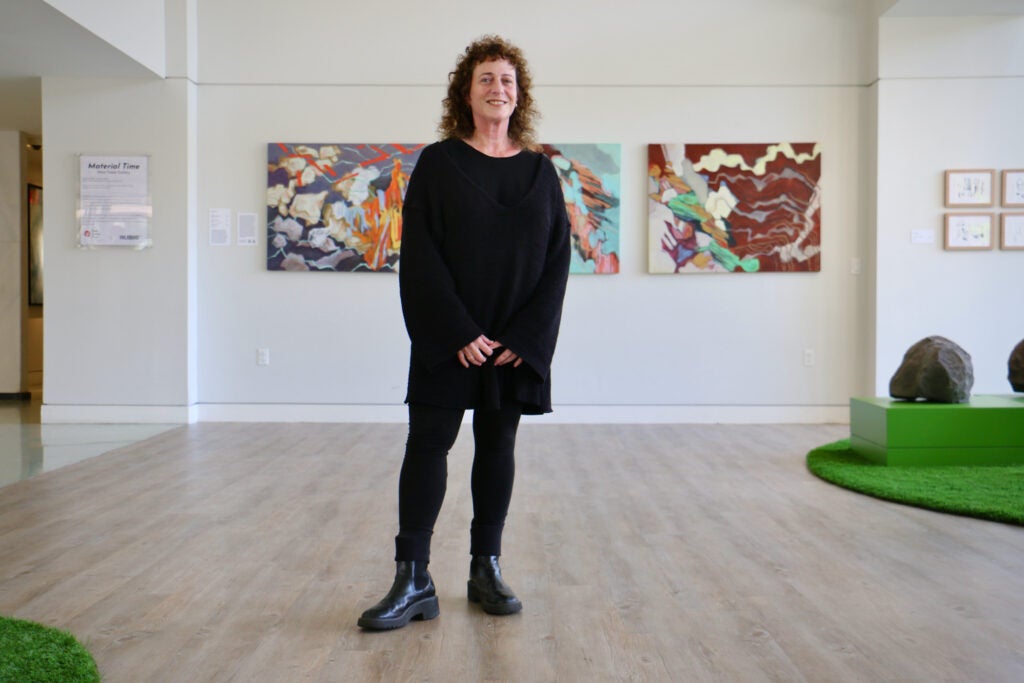 Rachel Zimmerman stands in the middle of a gallery