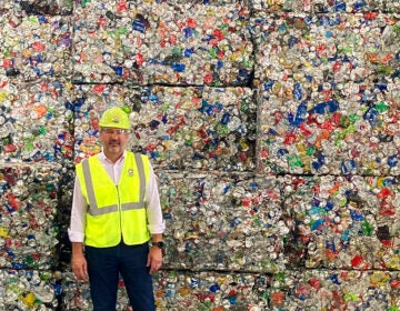 Pete Keller, vice president of sustainability for Republic Resources poses for a photo at a facility in Oberlin, Ohio, in front of cubes of compressed plastic bottles
