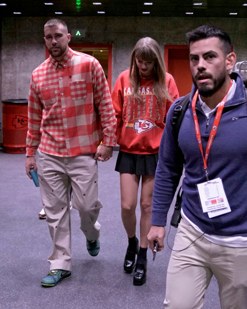 Kansas City Chiefs tight end Travis Kelce (left) and singer Taylor Swift leave Arrowhead stadium after an NFL football game between the Chiefs and the Los Angeles Chargers, Sunday, Oct. 22, 2023, in Kansas City, Mo.