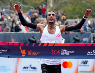 Tamirat Tola, of Ethiopia, crosses the finish line in the professional men's division of the New York City Marathon, Sunday, Nov. 5, 2023, in New York. (