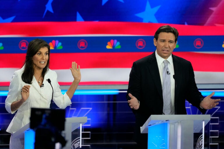 Republican presidential candidates former U.N. Ambassador Nikki Haley and Florida Gov. Ron DeSantis talk during a Republican presidential primary debate hosted by NBC News, Wednesday, Nov. 8, 2023, at the Adrienne Arsht Center for the Performing Arts of Miami-Dade County in Miami.