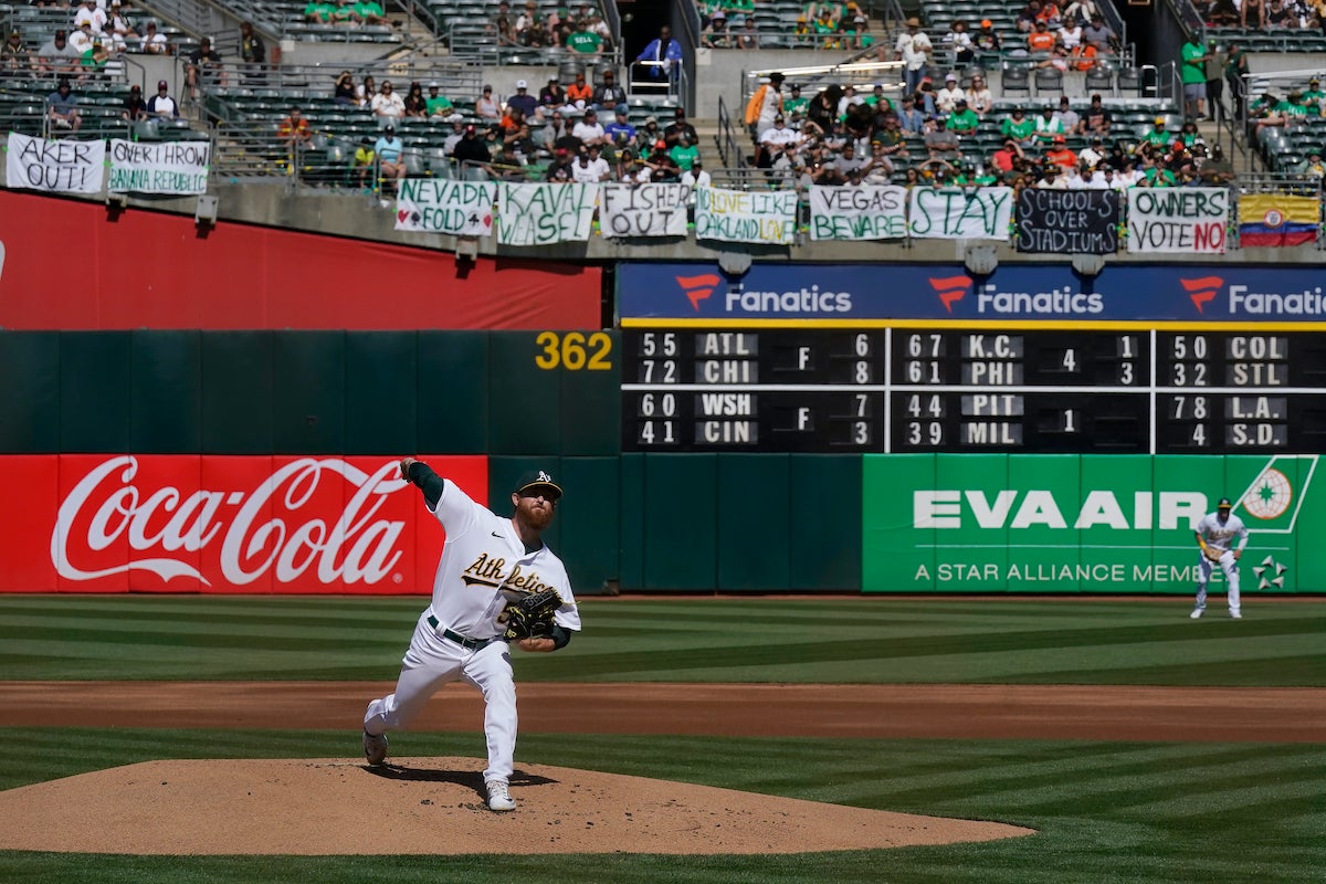 File photo: Oakland Athletics' Paul Blackburn pitches against the San Francisco Giants below signs hanging in right field protesting the team's potential move to Las Vegas and to call for management to sell the team during the first inning of a baseball game in Oakland, Calif., Saturday, Aug. 5, 2023.