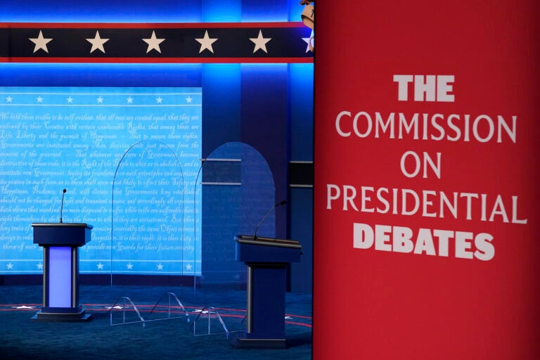 File photo: Clear protective panels stand onstage between lecterns as preparations take place for the second Presidential debate at Belmont University, Oct. 21, 2020, in Nashville, Tenn.