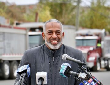 Camden Mayor Vic Carstarphen grins after announcing the final phase of the removal of the mound of dirt and debris illegally dumped at 7th and Chestnut streets.