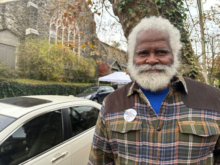 A Philadelphia voter poses for a photo outside their polling place