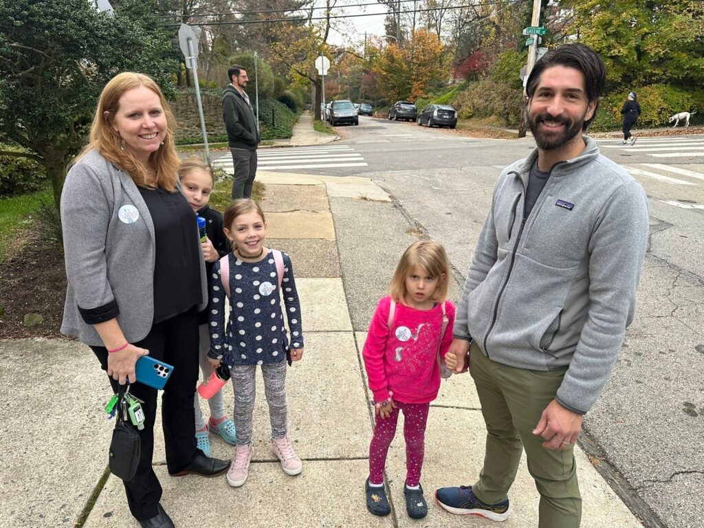 A family poses for a photo outside their polling place