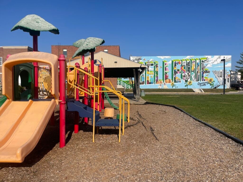 A playground and a mural in the background that reads Bellevue