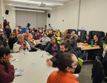 A group of people sitting at tables during the conversation.