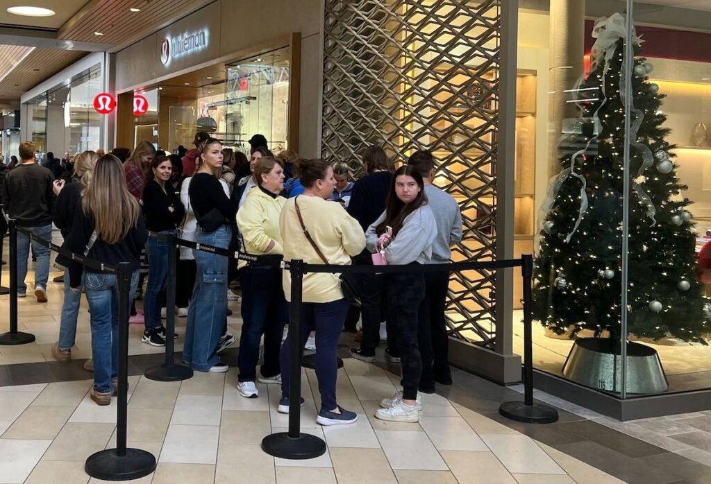 Shoppers wait in line outside of Lululemon at Christiana Mall.