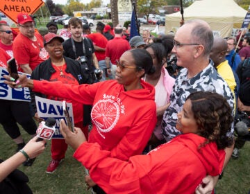 United Auto Workers President Shawn Fain posed with UAW members as they strike the General Motors Lansing Delta Assembly Plant in Michigan in late September.