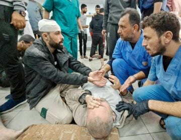 Palestinian medics listen to a man as the wounded are brought to the Kamal Adwan hospital in Beit Lahia in Gaza following Israeli bombardment on Tuesday. The hospital is situated just a few miles south of the Indonesian hospital, which was hit Monday by Israeli shelling, according to Palestinian officials. AFP via Getty Images