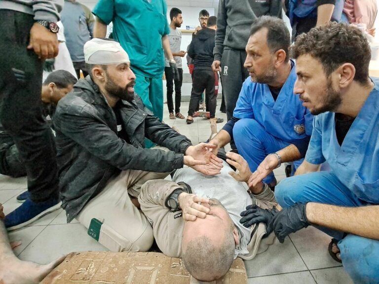 Palestinian medics listen to a man as the wounded are brought to the Kamal Adwan hospital in Beit Lahia in Gaza following Israeli bombardment on Tuesday. The hospital is situated just a few miles south of the Indonesian hospital, which was hit Monday by Israeli shelling, according to Palestinian officials. AFP via Getty Images