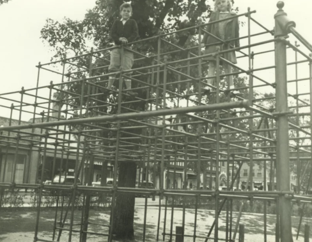 Archival photo of kids playing on a jungle gym