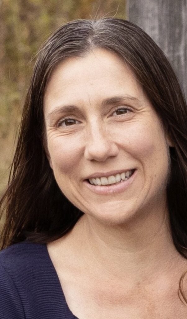 A headshot of Jen Sheldon, smiling and posing for a photo