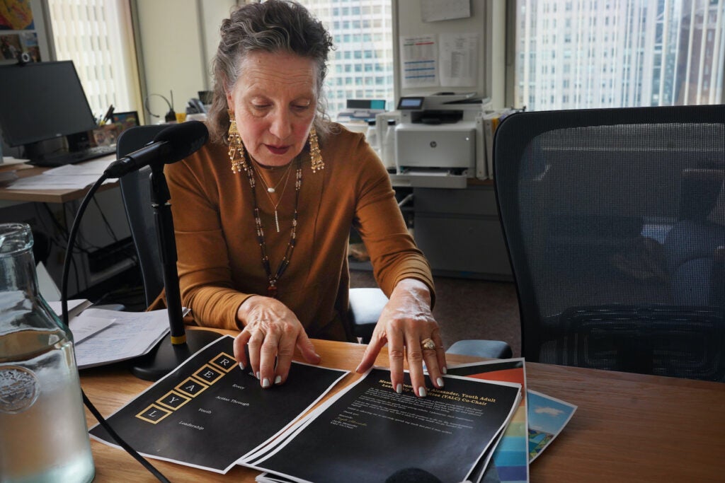 Liz Hersh sitting at a table with papers