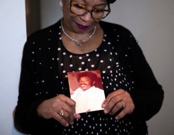 Mary Buffaloe looking at a photograph of her brother.