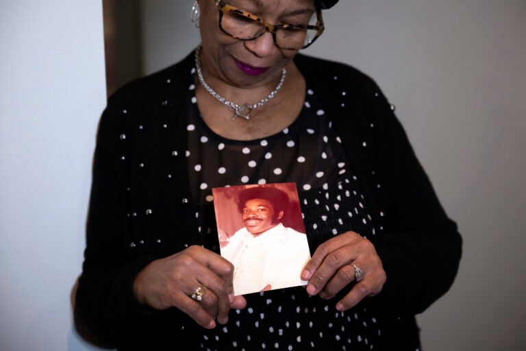 Mary Buffaloe looking at a photograph of her brother.