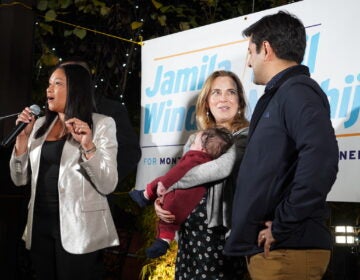 Montgomery County Democrats Jamila Winder and Neil Makhija celebrate next to the podium with their families.