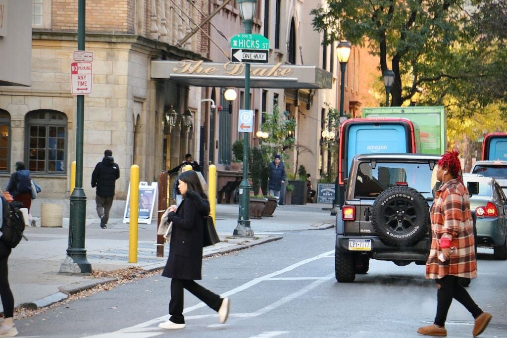 People cross a street in Philadelphia