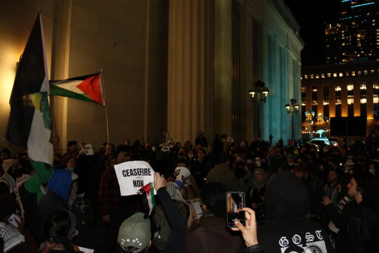 Protesters holding Palestinian flag and a sign that reads Ceasefire now gather outside of Philadelphia's 30th Street Station