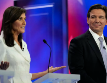 Republican presidential candidate former U.N. Ambassador Nikki Haley speaks as Florida Gov. Ron DeSantis listens during a Republican presidential primary debate hosted by NBC News on Wednesday in Miami.