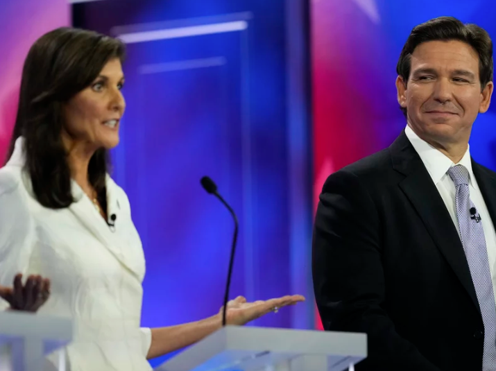 Republican presidential candidate former U.N. Ambassador Nikki Haley speaks as Florida Gov. Ron DeSantis listens during a Republican presidential primary debate hosted by NBC News on Wednesday in Miami.