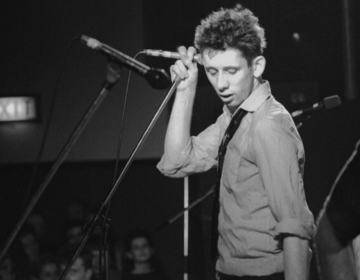 Shane MacGowan performing on stage