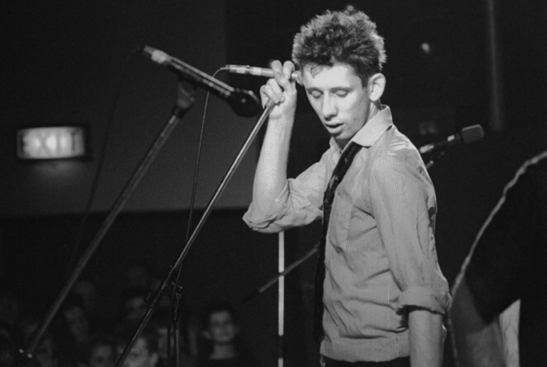 Shane MacGowan performing on stage