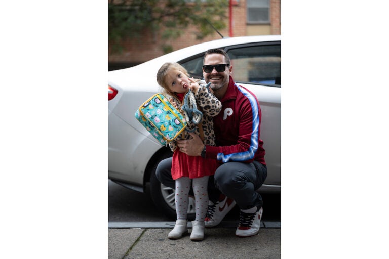 A father poses with his daughter