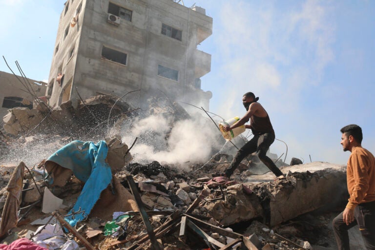 Palestinians extinguish the fire after an Israeli airstrike