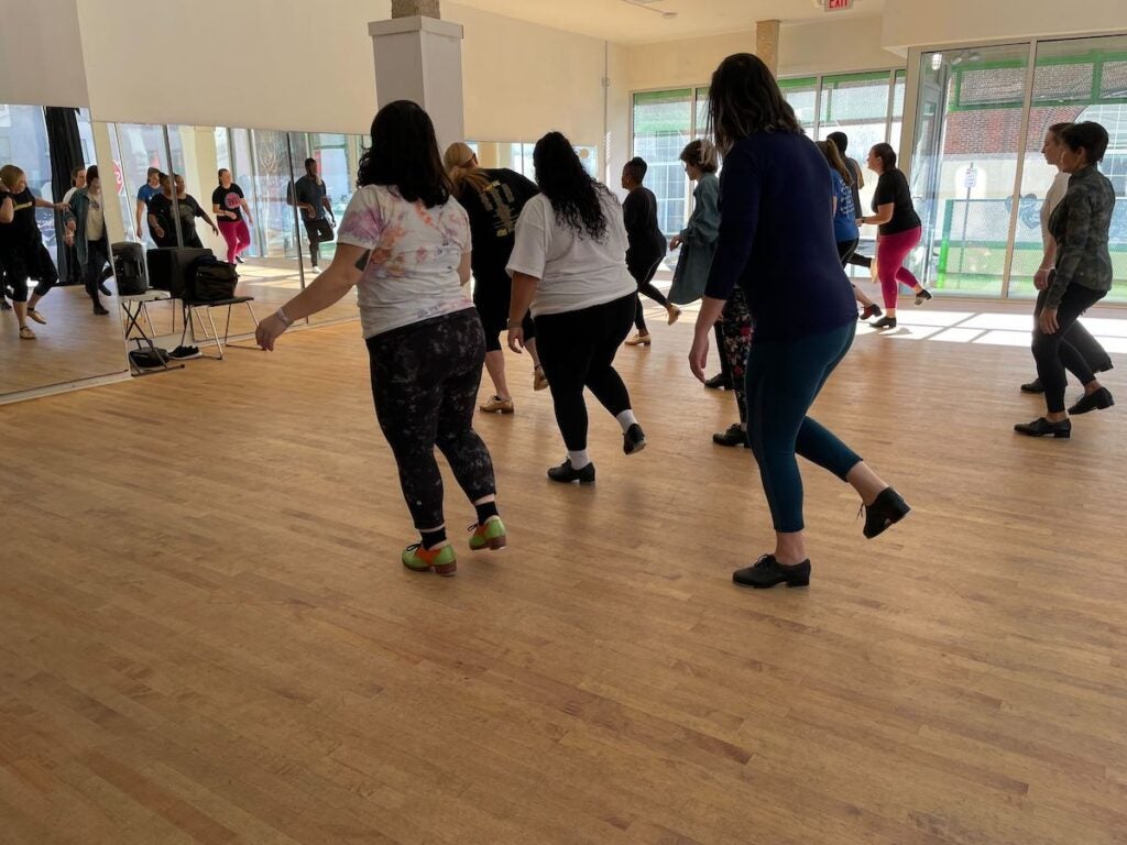 Tap dancers practicing in a dance studio