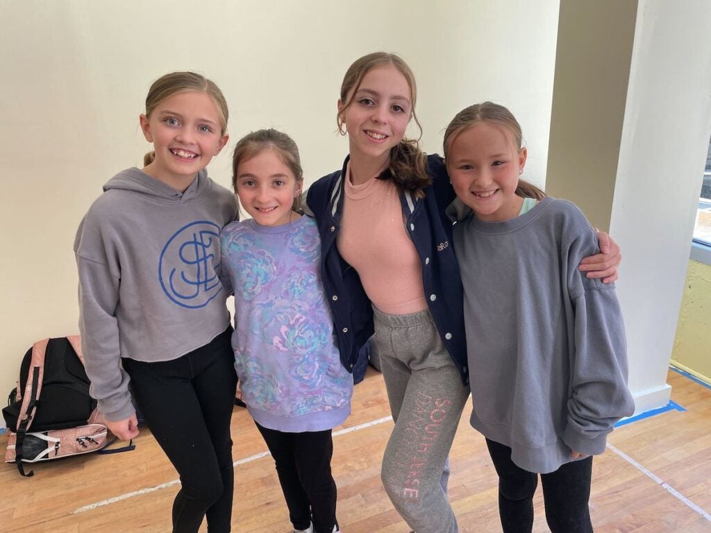 Mia, second from right, and her tap dancing buddies pose for a photo.