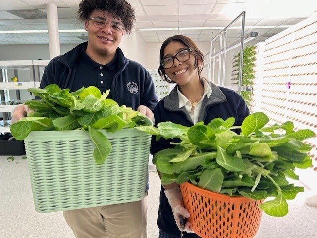 Students holding plants