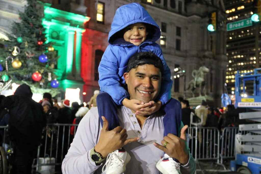 Kimo Laemoa poses for a photo with his son, Daniel, on his shoulders