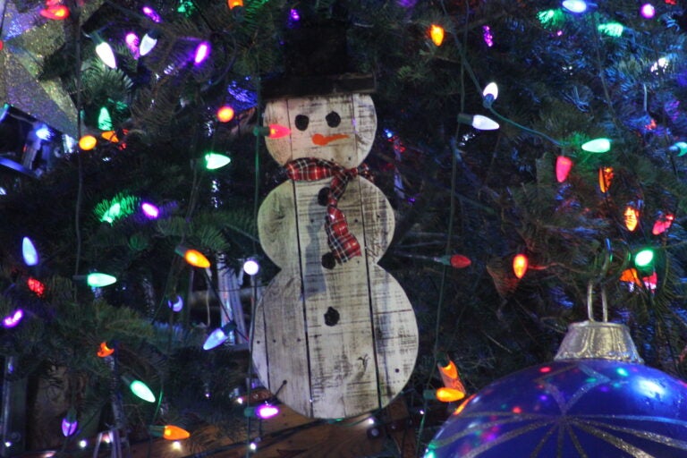 A snowman ornament on a tree