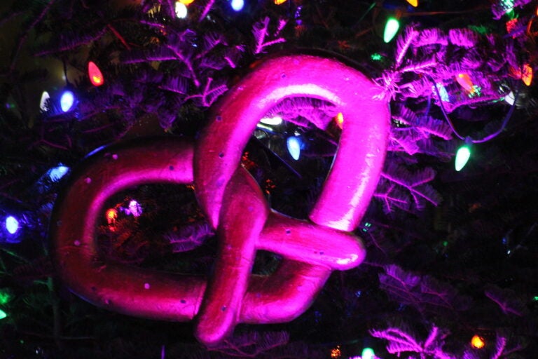 A soft pretzel ornament on a tree