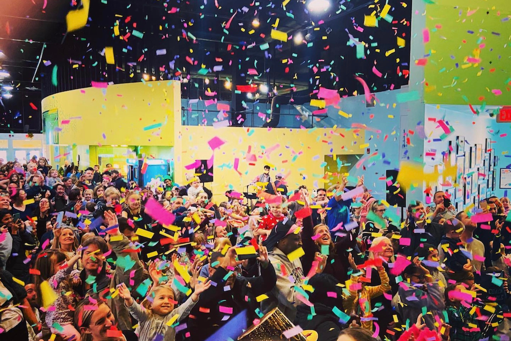 Families and children celebrate the new year amid the excitement of confetti cannons going off.