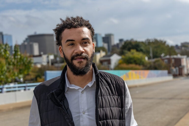 Branden Fletcher Dominguez poses for a photo in front of a road.