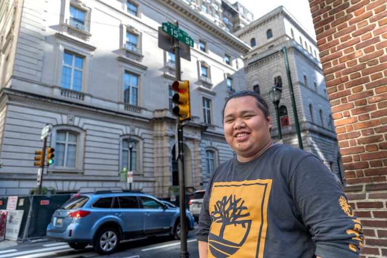 Paulo Garcia poses for a photo at a street corner