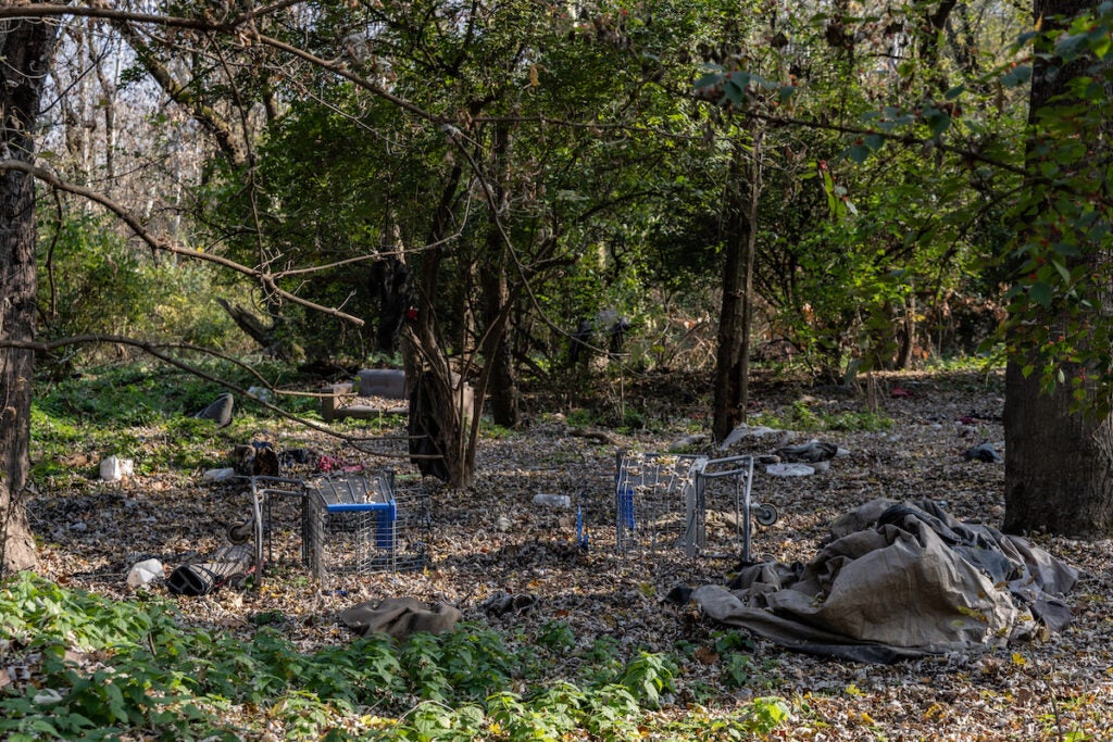 trash strewn on the ground at the encampment after the flood.